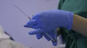 医師の手に注射器